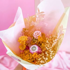 Bouquet of dried flowers in warm white, pink and yellow tones