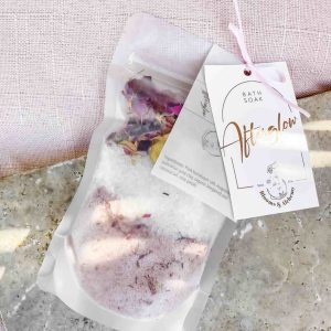 A bath soak pack featuring Himalayan pink salt, Dead Sea salt, pink Australian clay, and flowers.